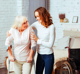 caregiver attending to an elderly woman