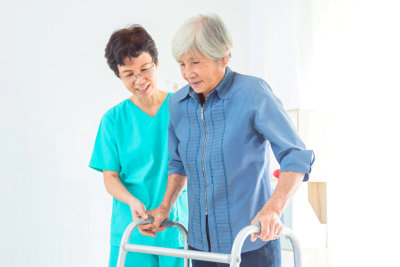 old woman assisted by her nurse