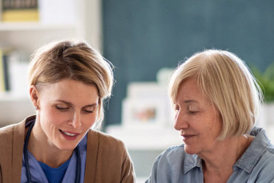 nurse talking to senior woman 