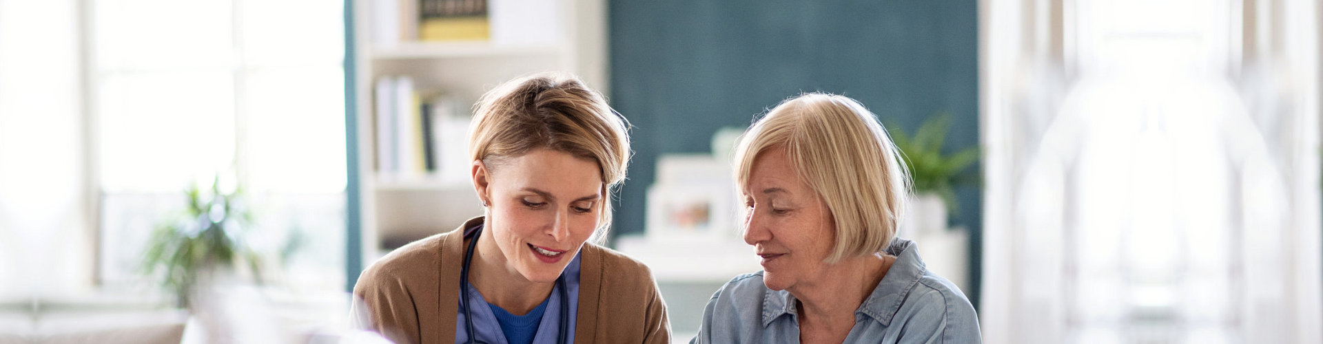 nurse talking to senior woman