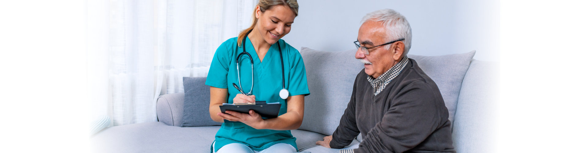 nurse measuring blood pressure of senior man at home