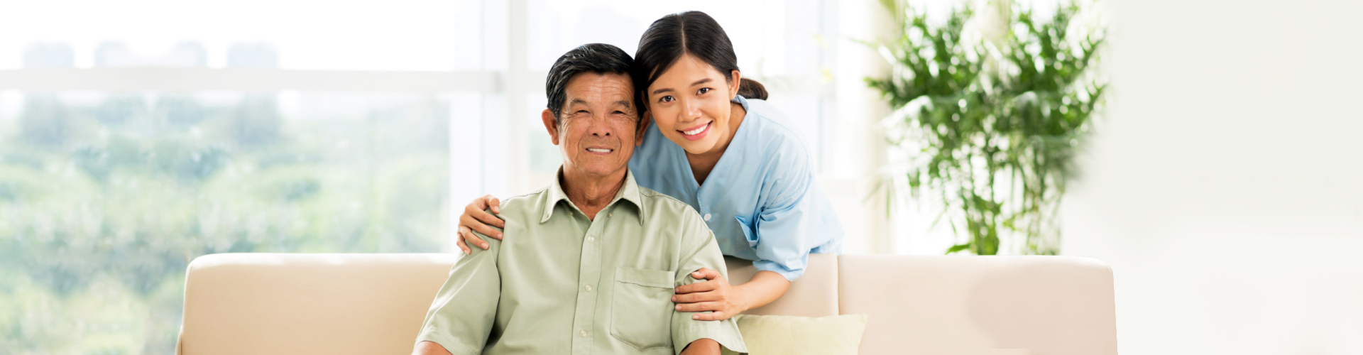 caregiver smiling with elderly man